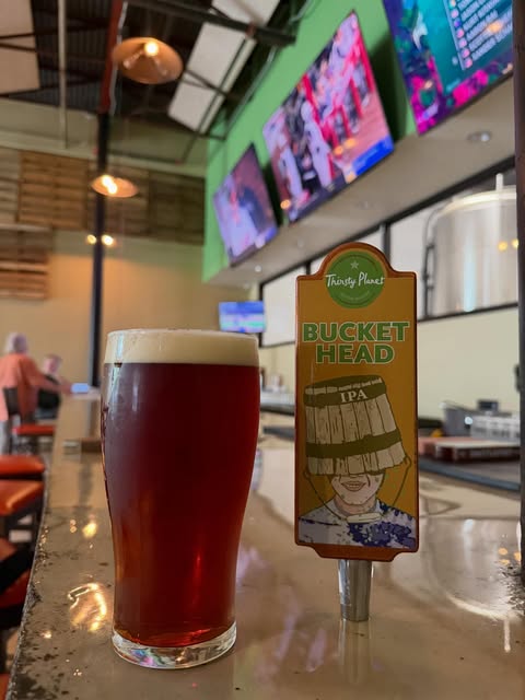 Buckethead IPA poured at the bar beside its tap handle