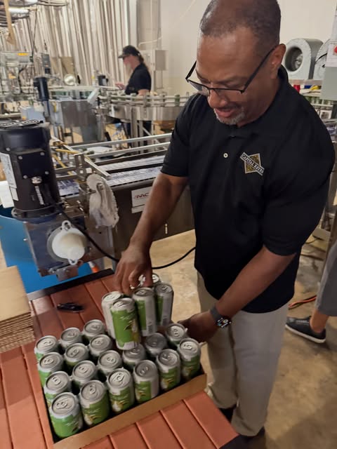 Packing Thirsty Goat cans into trays at the brewery